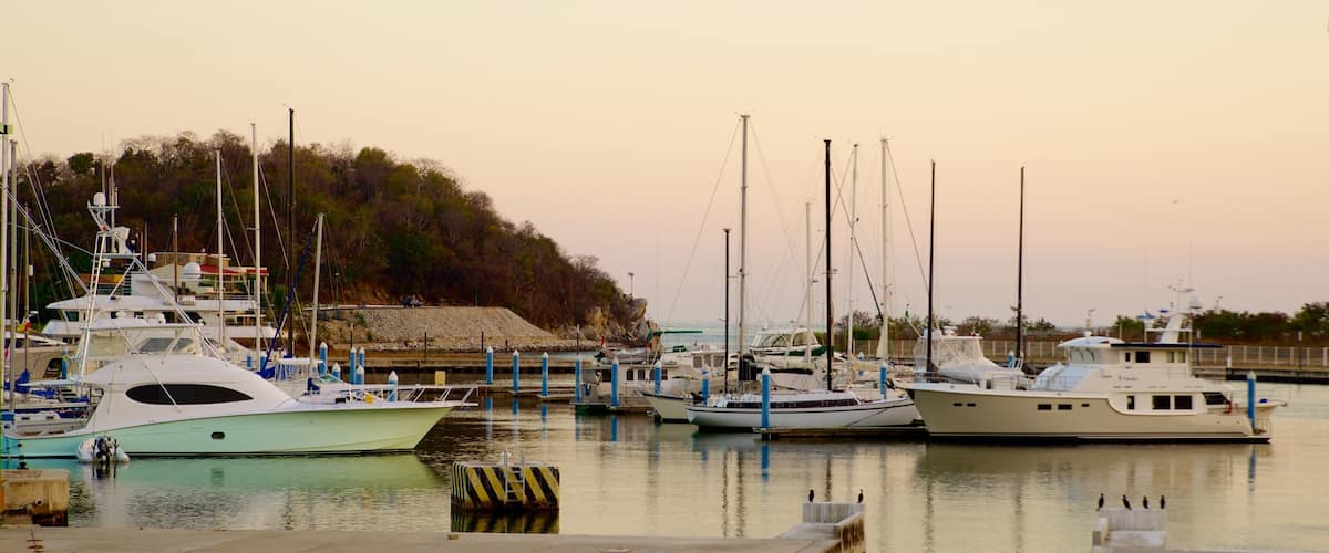Marina Chahue which includes a bay or harbour, boating and a sunset
