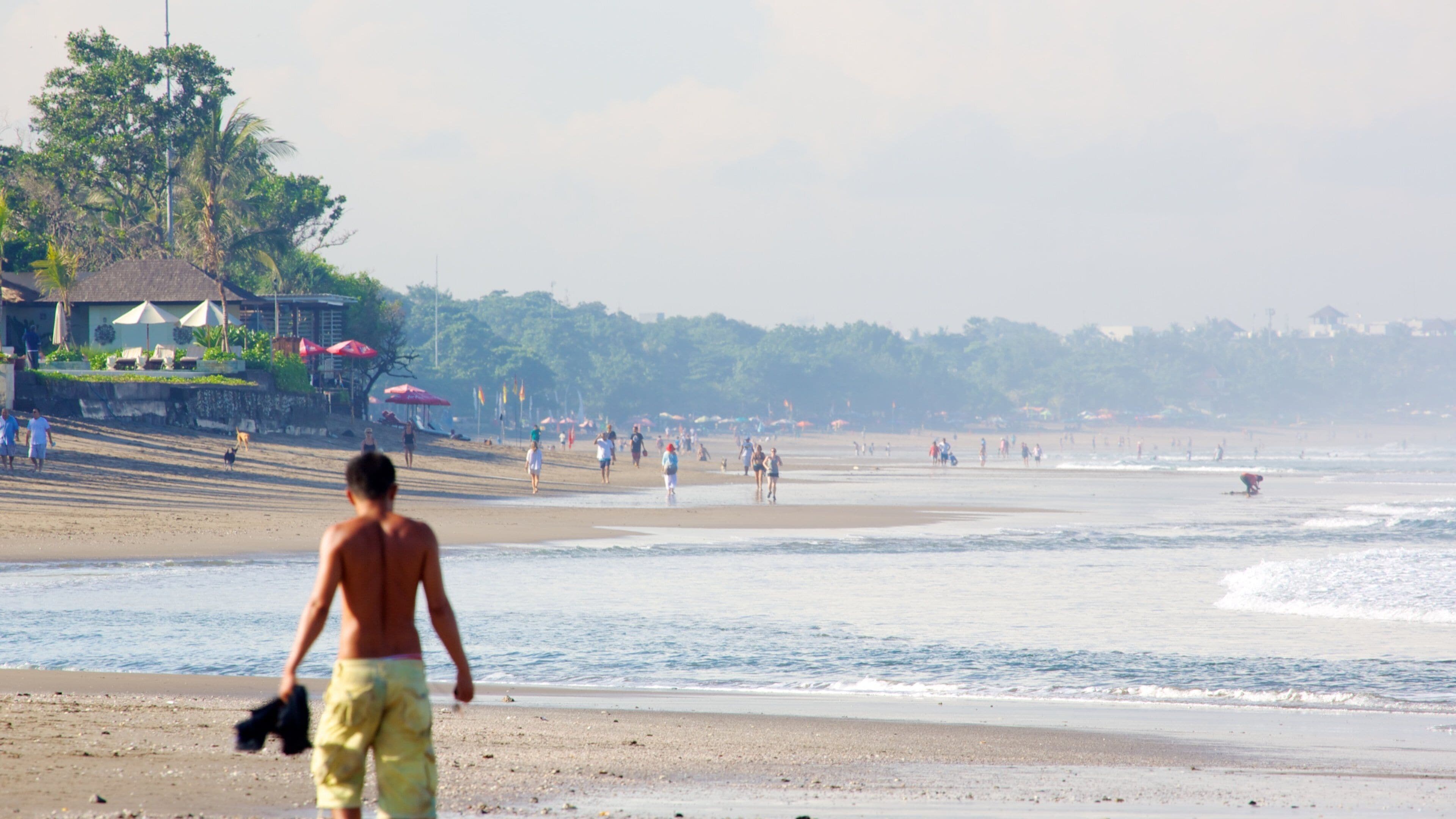 Seminyak Beach featuring a beach as well as an individual male