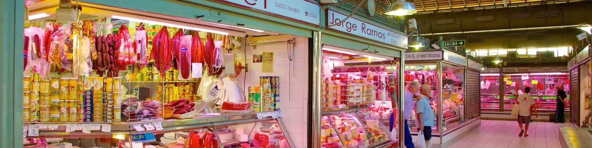 A market with various food items on display, including cheeses and meats.