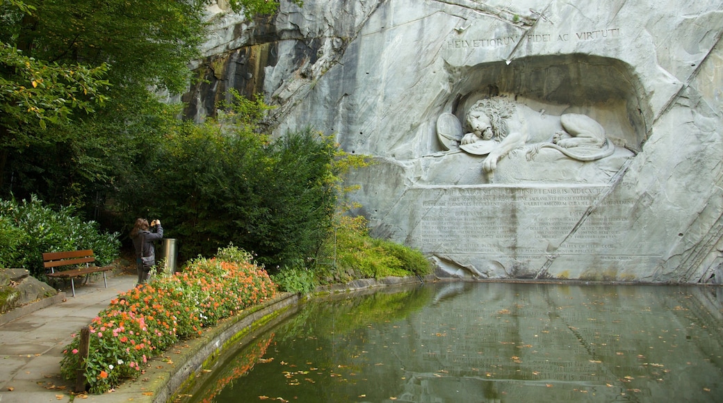 Lion Monument which includes a monument, a park and a pond