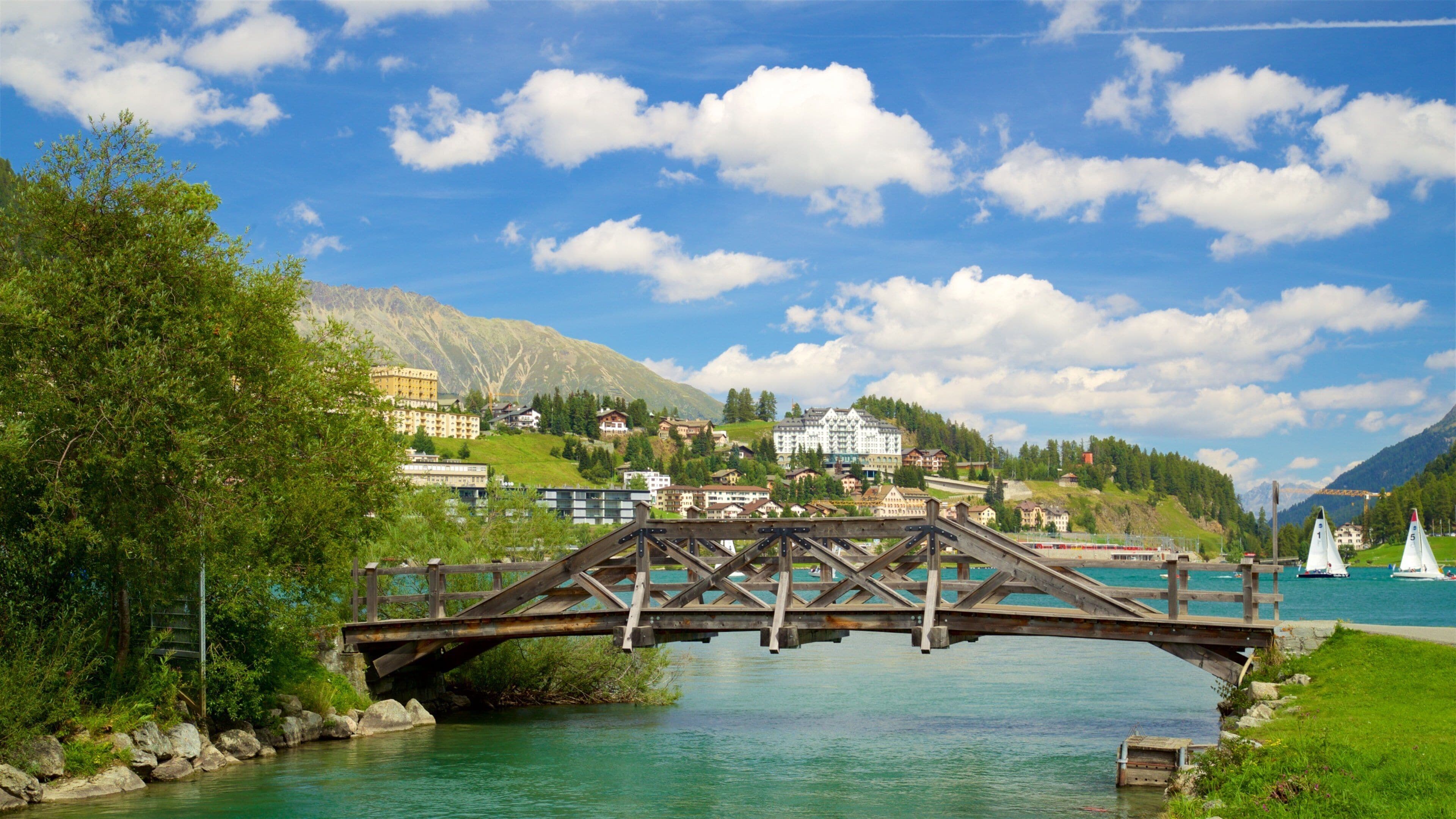 Lake St. Moritz featuring a river or creek, a small town or village and a bridge