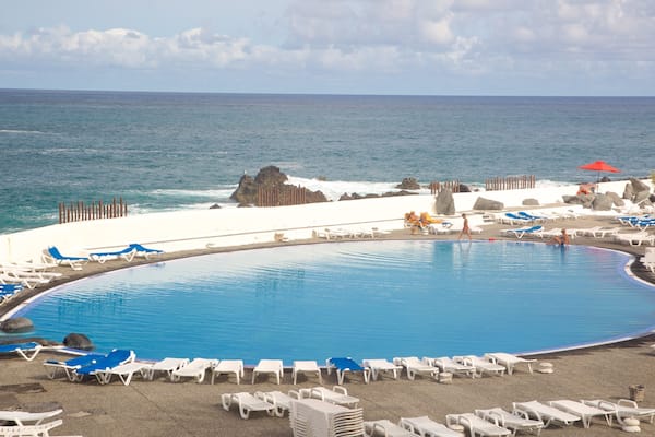 Lago Martianez Swimming Pools showing a luxury hotel or resort and a pool