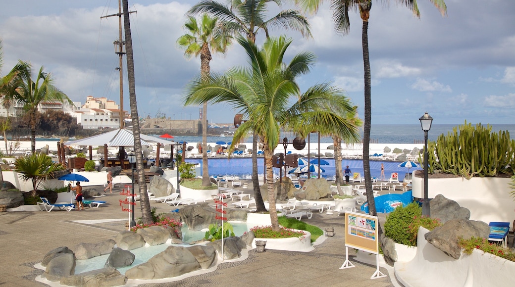 Lago Martianez Swimming Pools showing a luxury hotel or resort and a pool