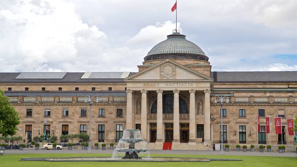 A historic building with a large dome and columns, featuring a fountain in front.