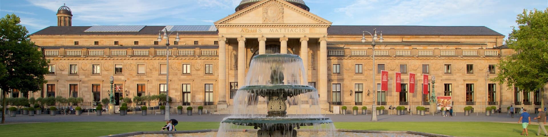 Kurhaus featuring heritage architecture, a fountain and a garden