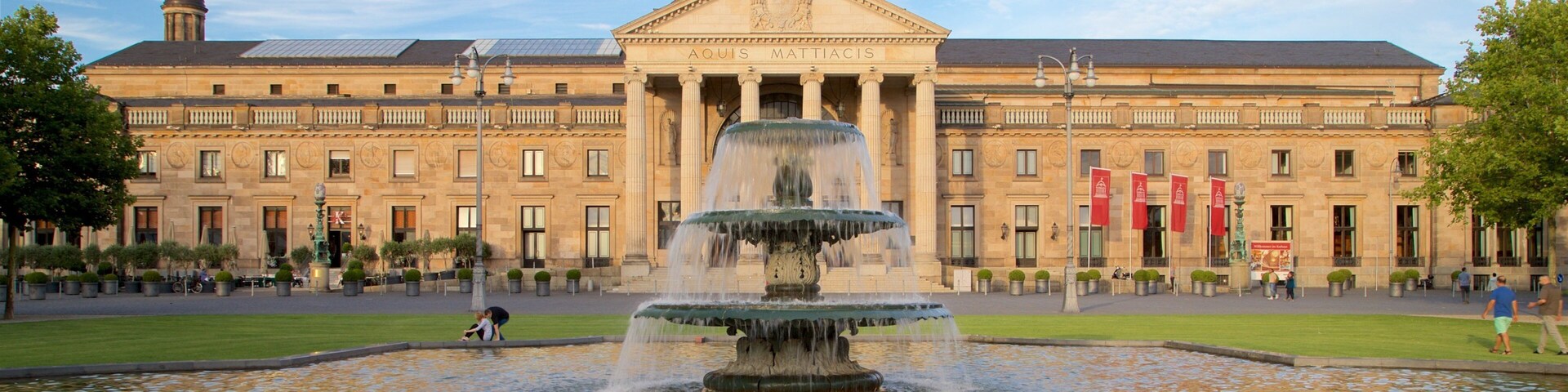 Kurhaus featuring heritage architecture, a fountain and a garden