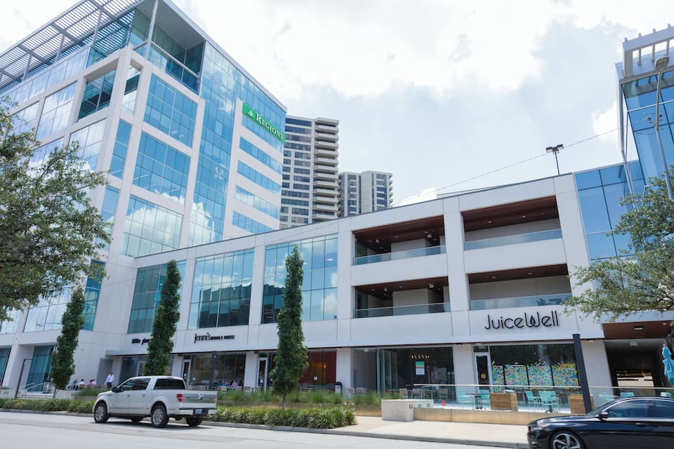 A modern building with glass windows and a sign for 'Regions'.