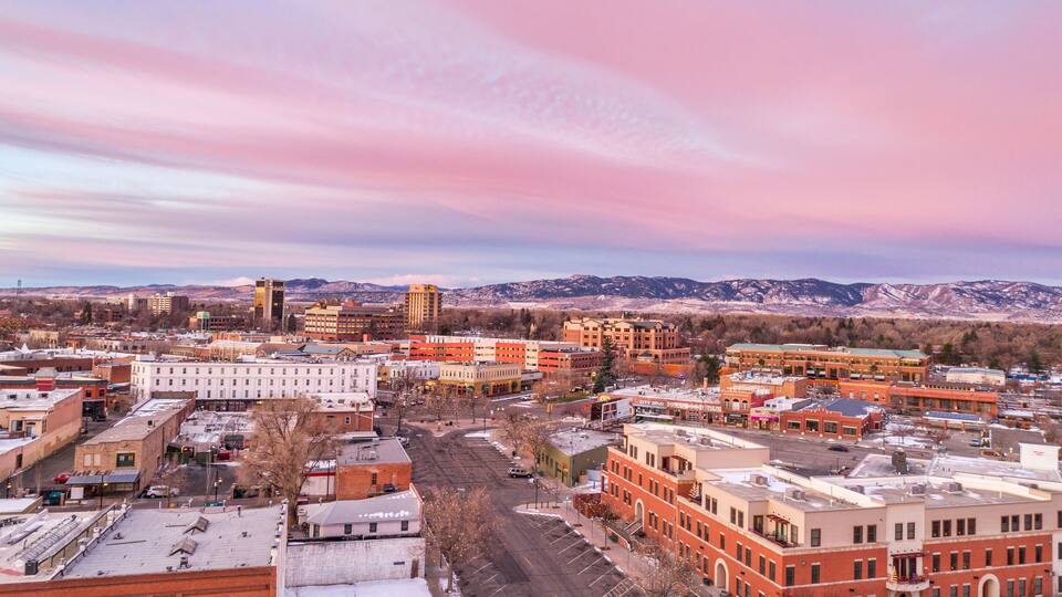 Fort Collins downtown in northern Colorado, aerial view with Rocky Mountains in background