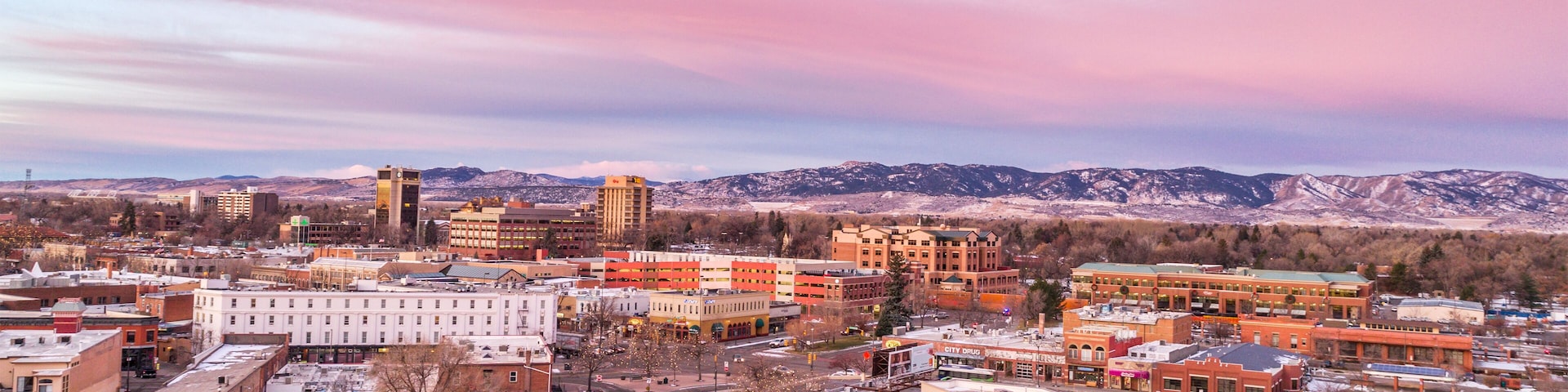 Fort Collins downtown in northern Colorado, aerial view with Rocky Mountains in background