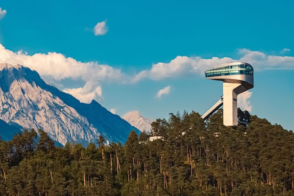 Alpine summer view with the famous Berg Isel Ski Jump Tower and the Nordkette mountains in the background near Innsbruck, Austria