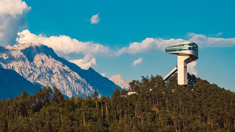 Alpine summer view with the famous Berg Isel Ski Jump Tower and the Nordkette mountains in the background near Innsbruck, Austria
