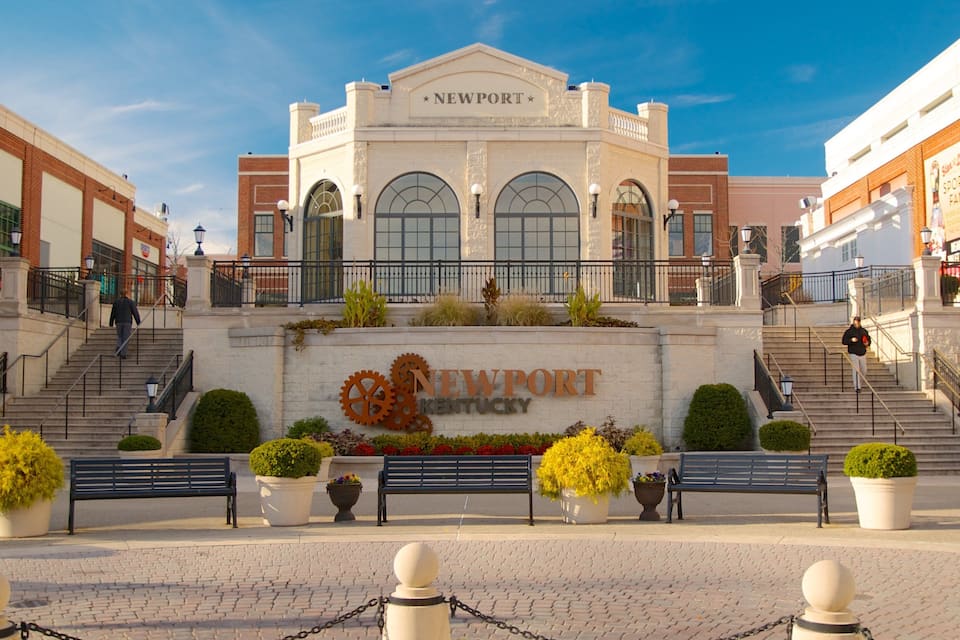 A historic building with arched windows and a sign reading "Newport Kentucky".