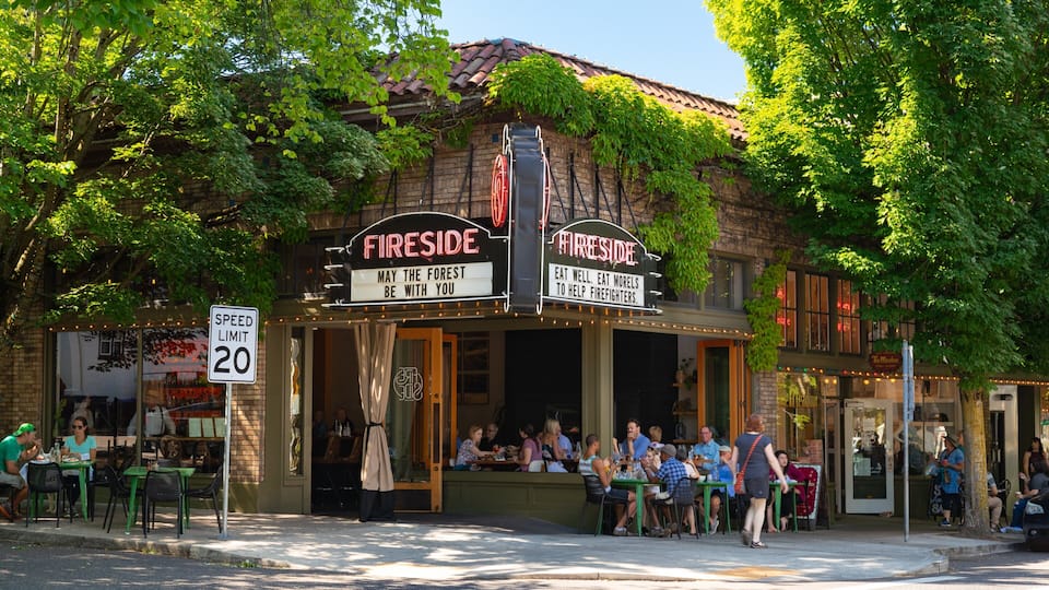 Nob Hill showing signage and outdoor eating as well as a small group of people