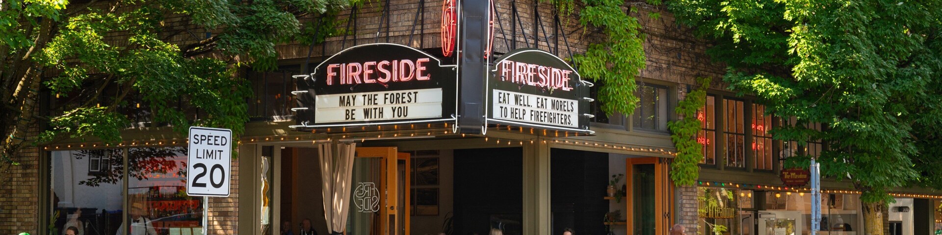 Nob Hill showing signage and outdoor eating as well as a small group of people