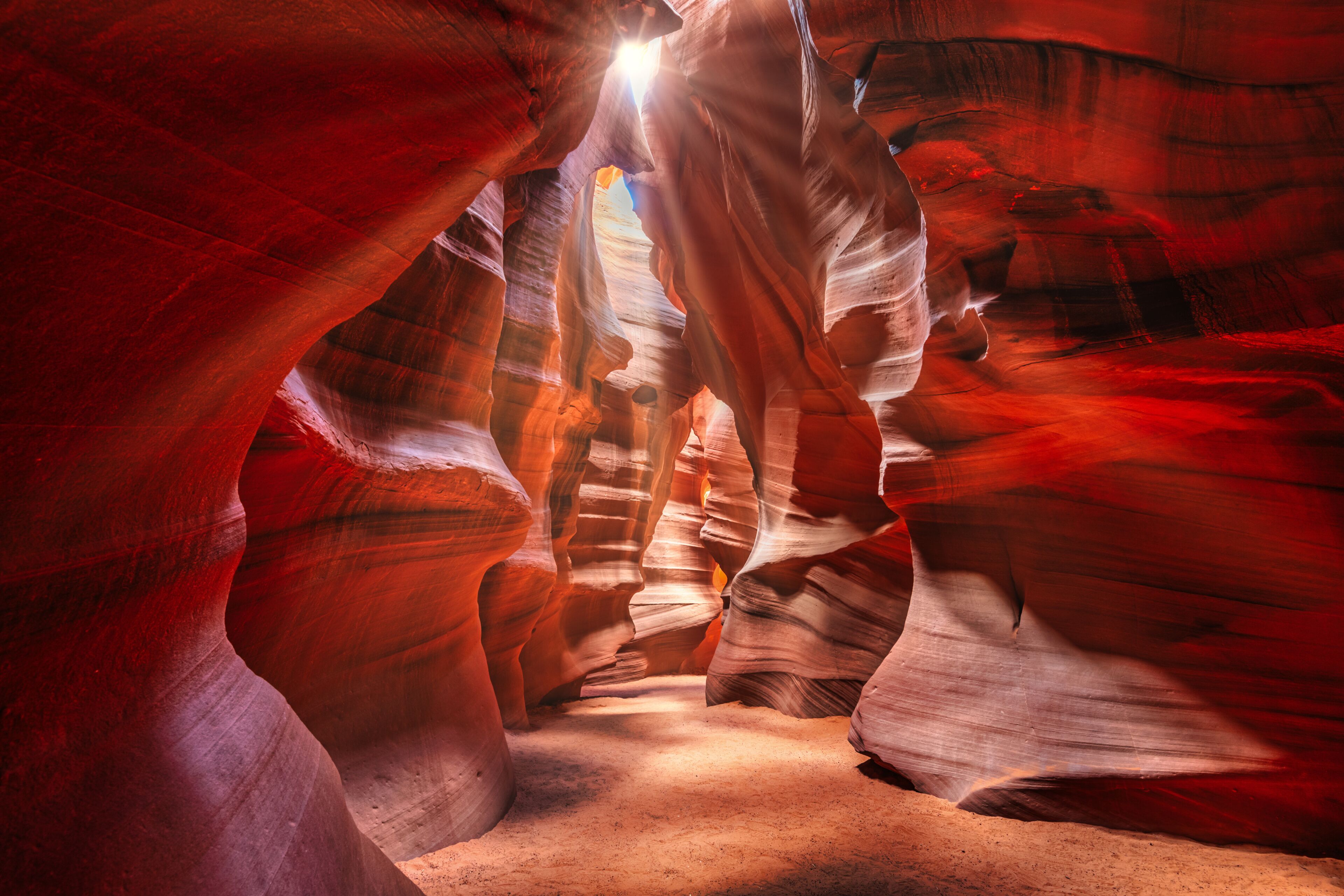 Beautiful wide angle view of sandstone formations in famous Antelope Canyon on a sunny day filtering light rays, Page, American Southwest, Arizona, USA.