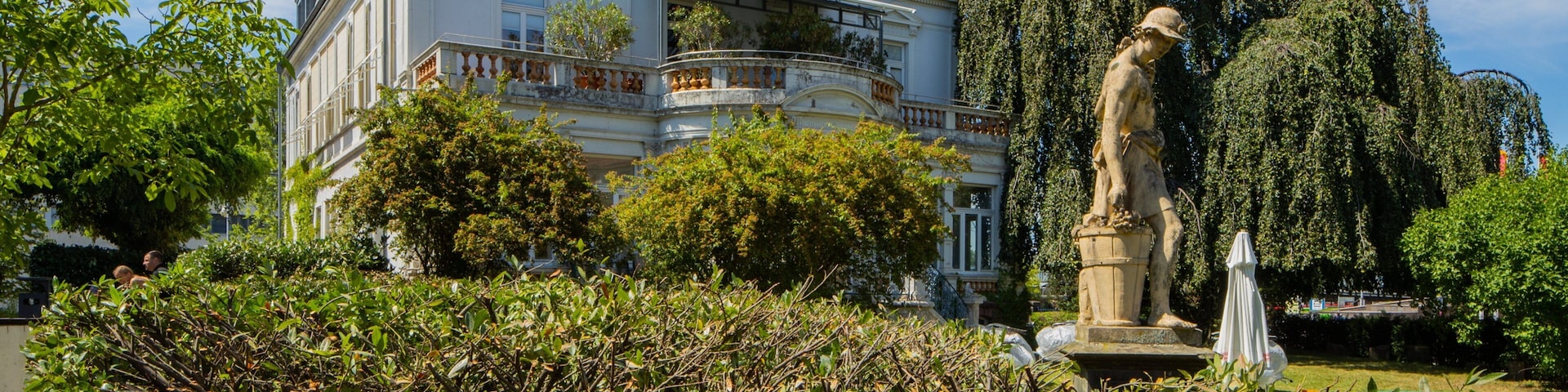 Goethe Institute featuring a house, a statue or sculpture and a garden