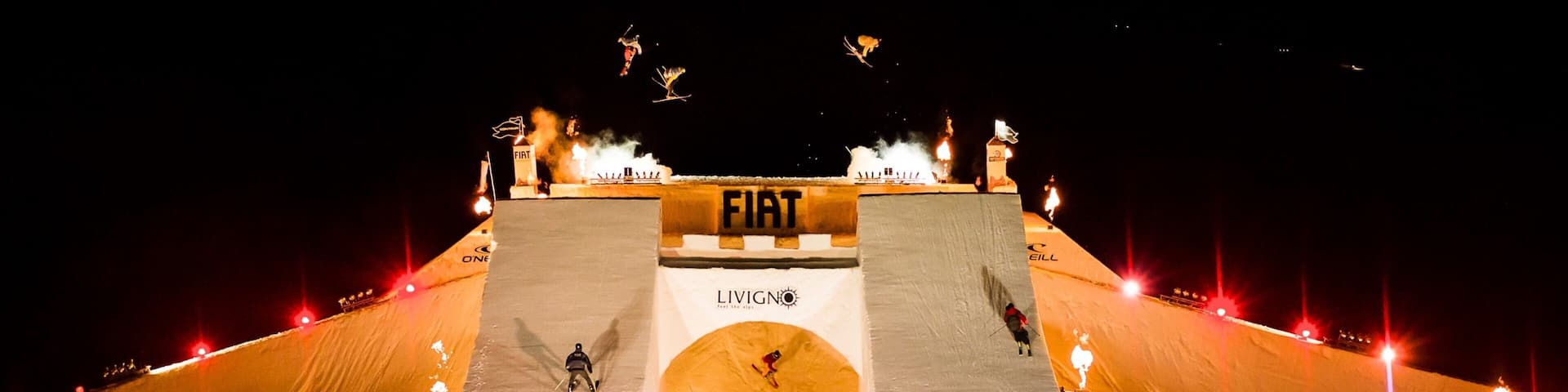 A snow-covered ramp with FIAT and LIVIGNO logos, surrounded by flames.