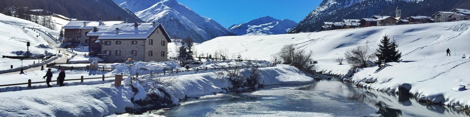 Livigno Ski Area featuring tranquil scenes, a pond and snow
