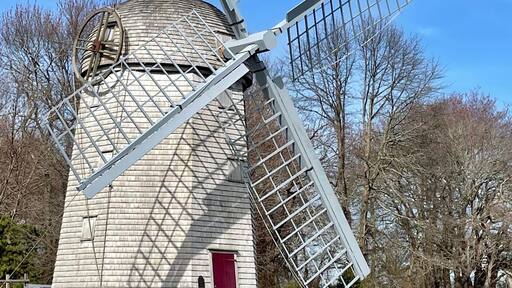 Majestic windmill in a lush green grassy field in Jamestown