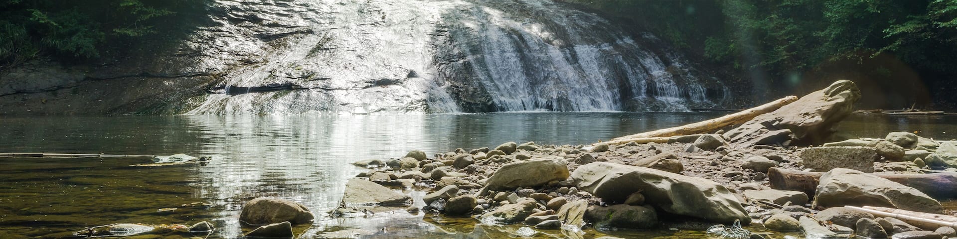 Japan travel concept - beautiful yoro keikoku valley waterfall under dramatic sun glow and morning blue sky in Chiba Prefecture, Japan