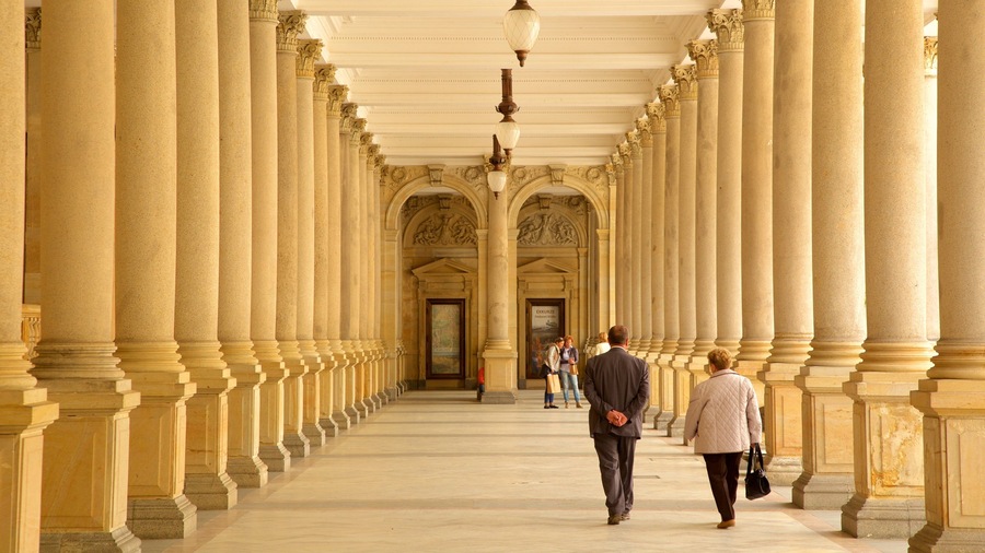 A grand hallway with tall columns and a high ceiling.