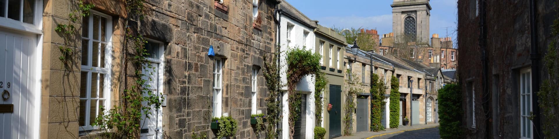 C2CW46 The view along Circus Lane looking towards St Stephen's Church in the Stockbridge area of Edinburgh's New Town.