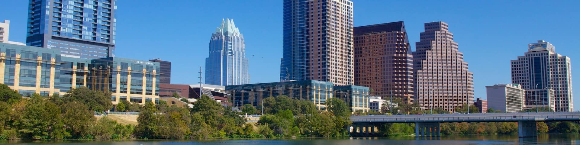 Lady Bird Lake featuring city views, skyline and a skyscraper