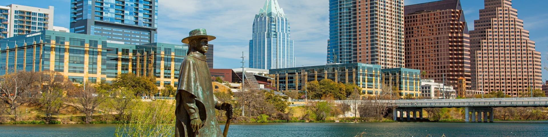 Lady Bird Lake featuring a city, a river or creek and a statue or sculpture