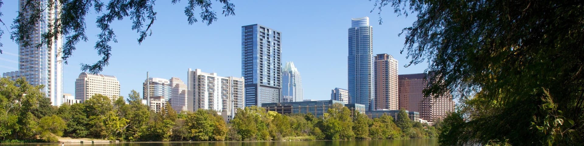 Reflections of Austin's skyline on Lady Bird Lake during a sunny day in Texas
