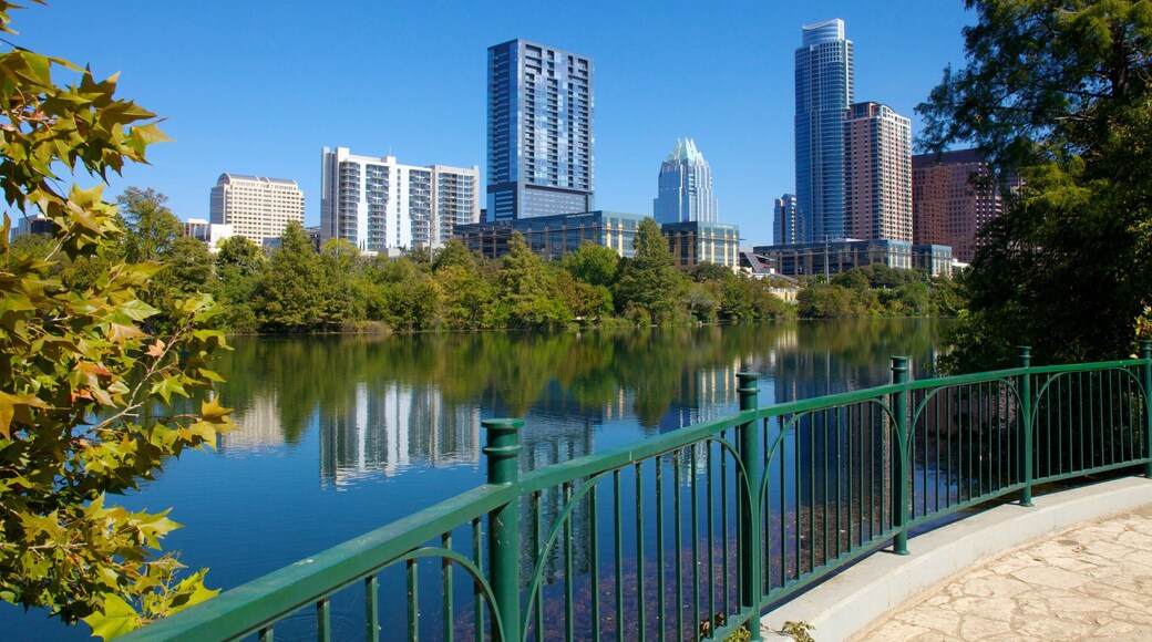 Lakefront view of downtown Austin with skyscrapers reflecting in Lady Bird Lake on a clear day