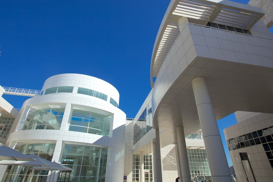A modern architectural building with a circular central section and large glass windows.