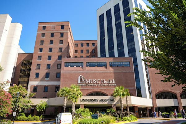 A medical university building with a prominent sign for MUSC Health and a University Hospital.