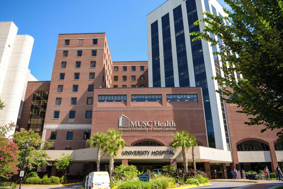 Un edificio de universidad de medicina con un letrero destacado para MUSC Health y un Hospital Universitario.