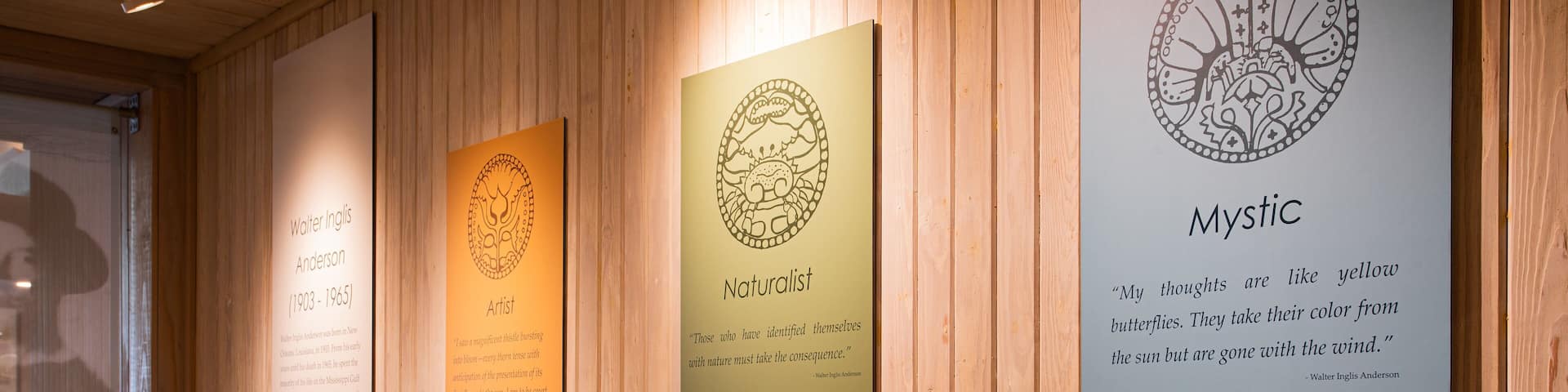 A wall with three vertical panels displaying information about Walter Inglis Anderson, an artist and naturalist.