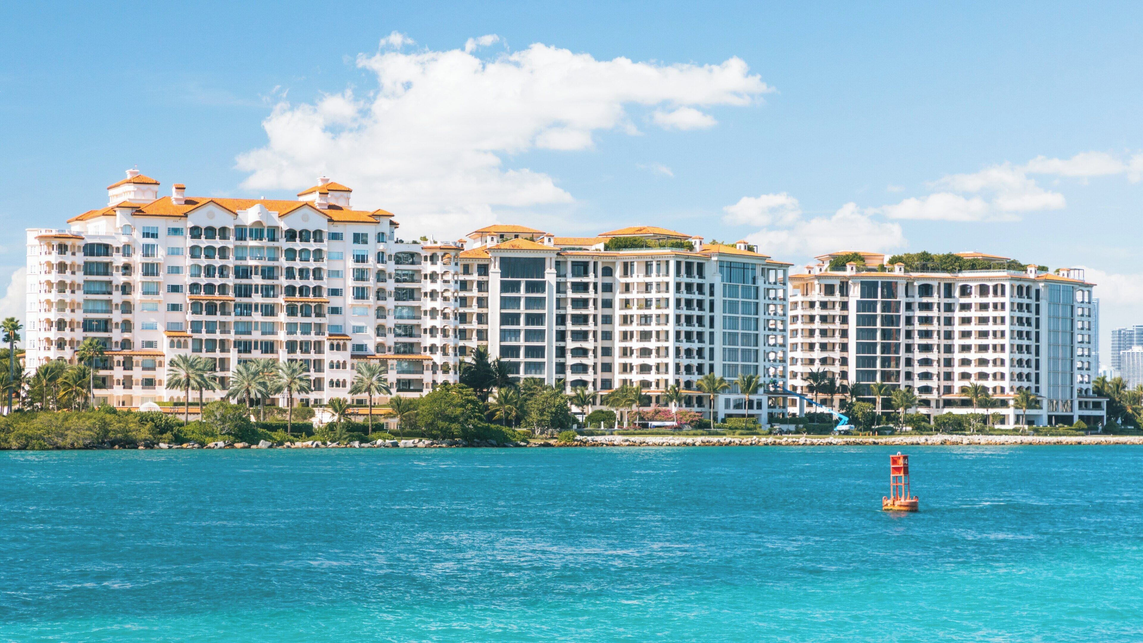 Luxurious beachfront residences along the turquoise waters of South Pointe Park in South Beach, Miami Beach on a sunny day