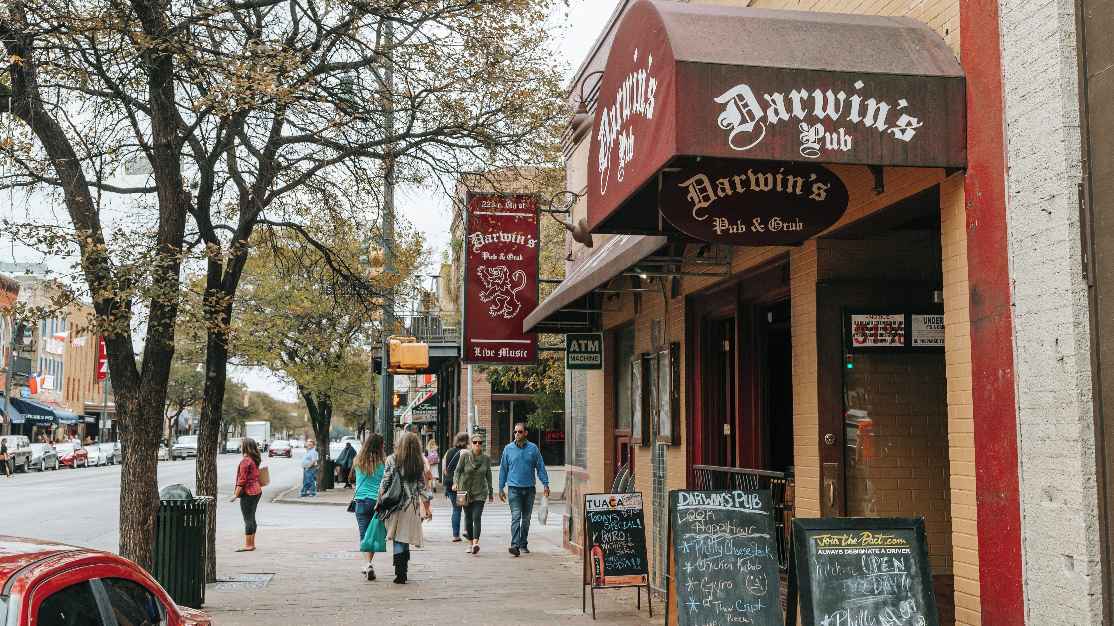 Exploring vibrant Sixth Street in Downtown Austin, Texas filled with lively pubs, restaurants, and pedestrians enjoying the atmosphere