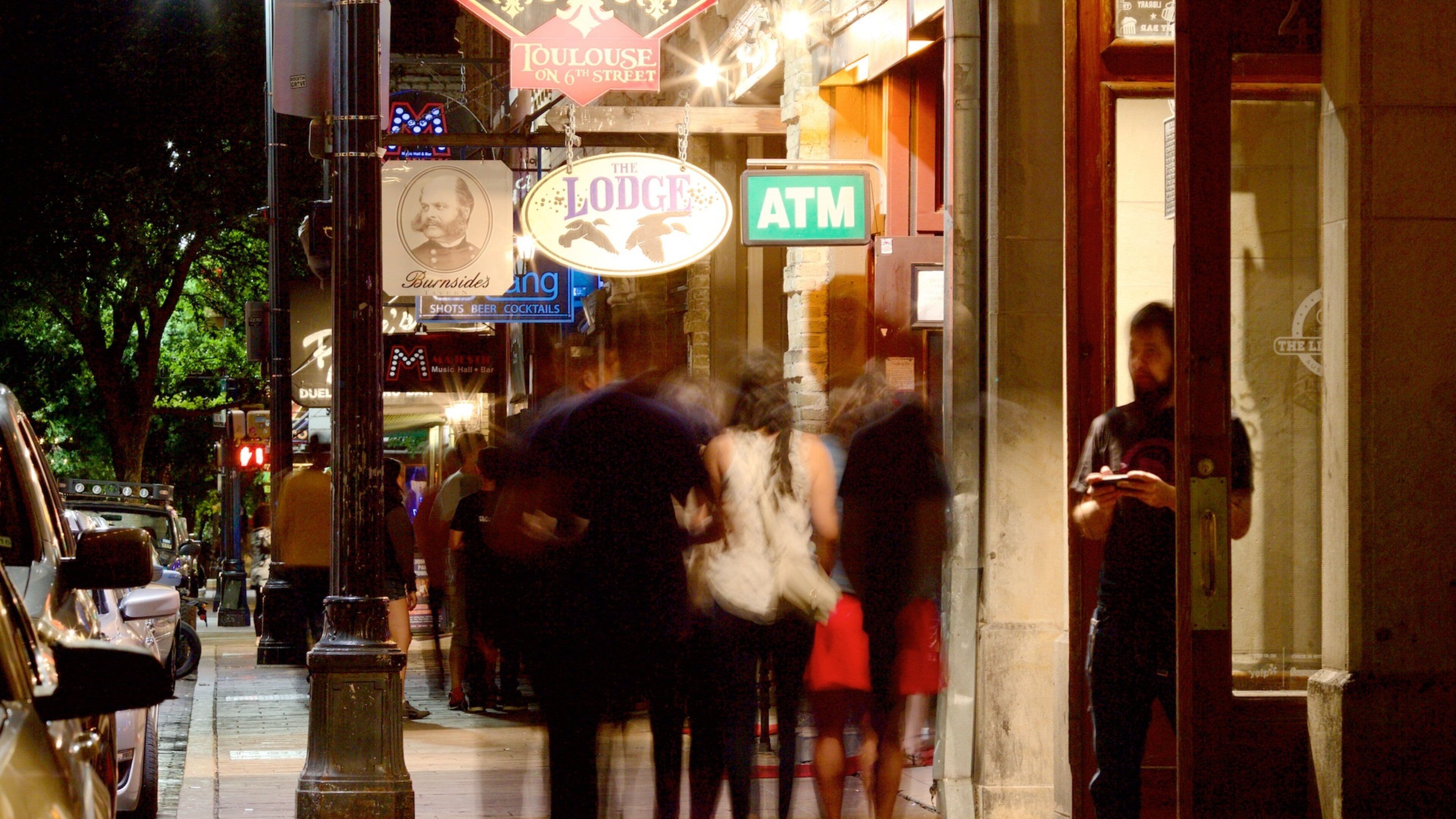 Sixth Street featuring night scenes, nightlife and a city