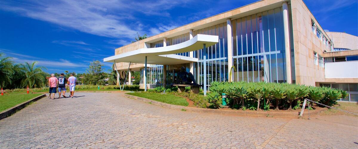 Pampulha Art Museum which includes a park and modern architecture as well as a small group of people