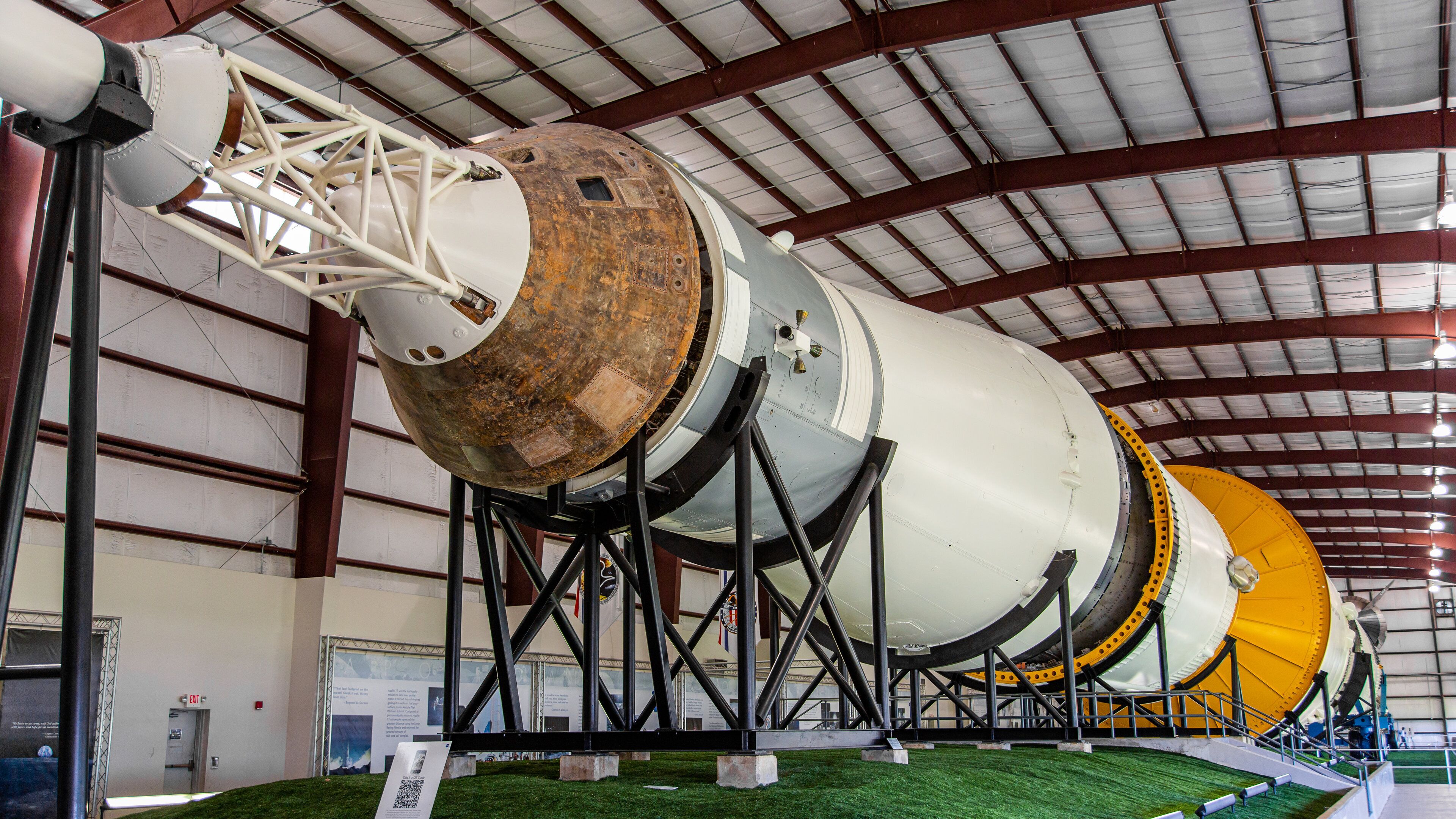 A large rocket on display in a hangar.
