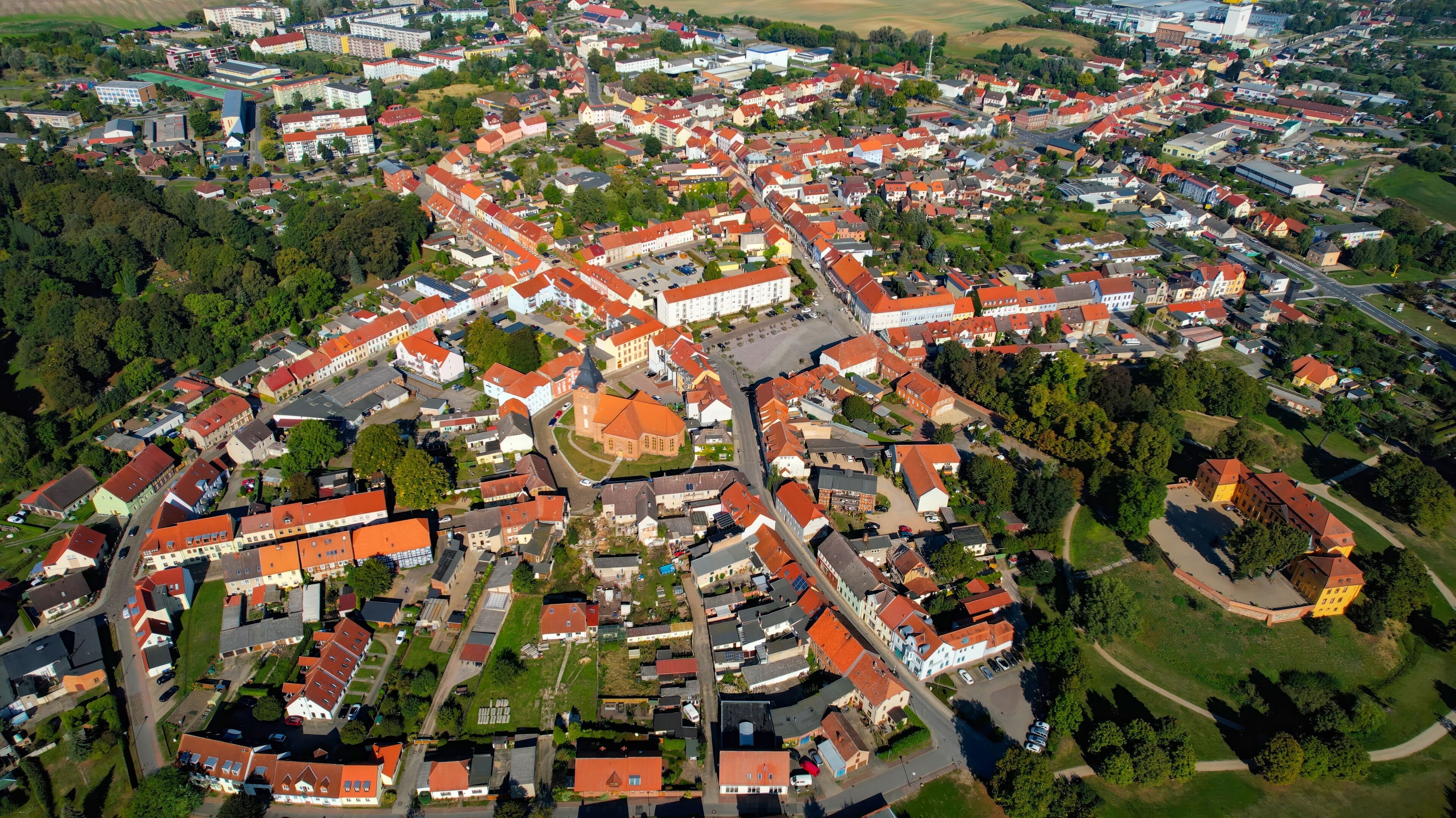 Aerial panoramic view around the old town of the city Stavenhagen on a sunny noon in summer in Germany.