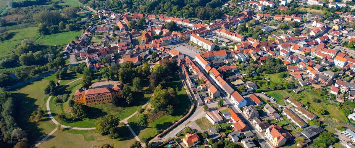 Aerial panoramic view around the old town of the city Stavenhagen on a sunny noon in summer in Germany.