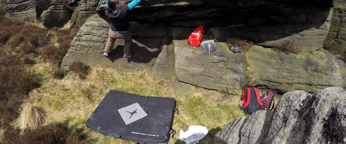 A person climbing a large rock formation.