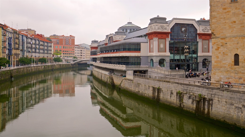 Ribera Market showing a river or creek, heritage architecture and a city