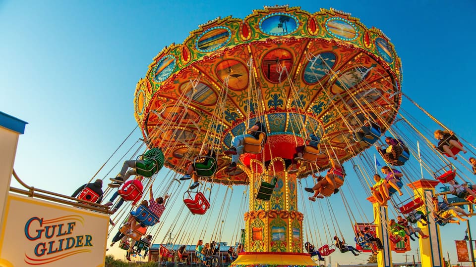 A colorful amusement park ride with multiple seats and a vibrant, ornate design.