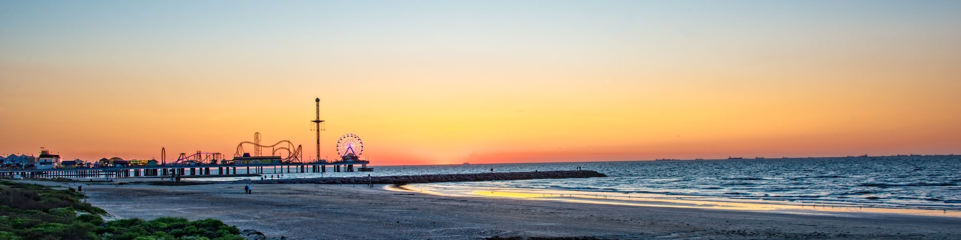 Sunrise on Galveston beach with pier