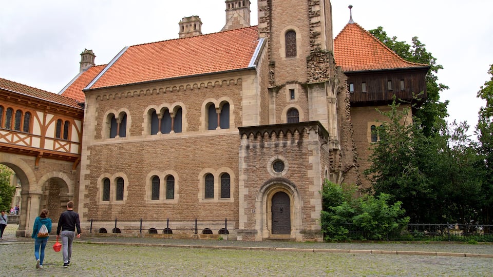 A historic building with a red-tiled roof, arched windows, and a stone facade.