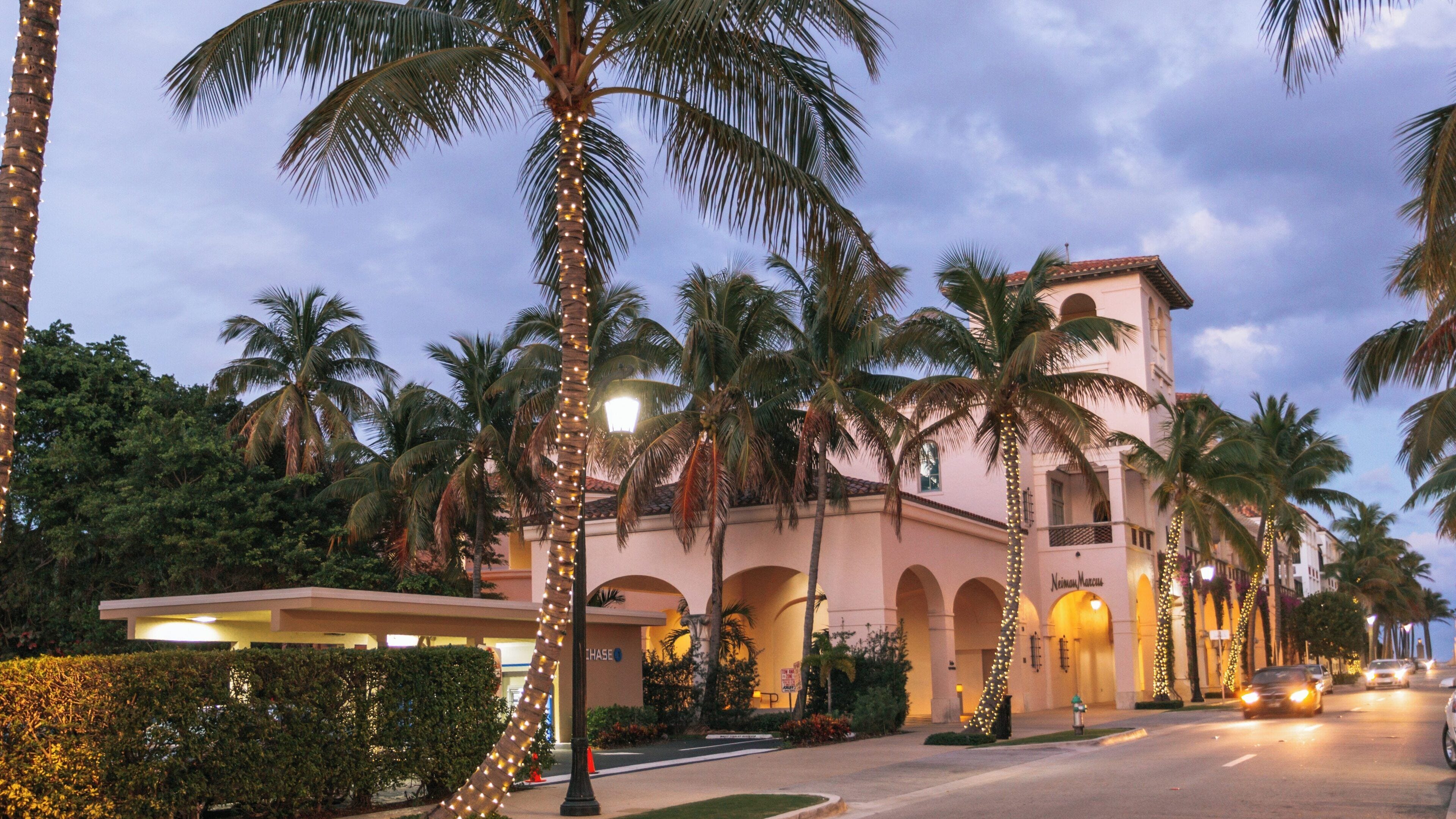 Strolling along Worth Avenue in Palm Beach, Florida on a beautiful evening with palm trees and festive lights