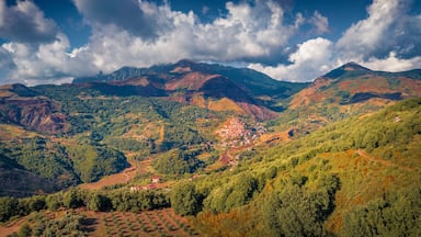 A mountainous landscape with a village nestled in the valley.