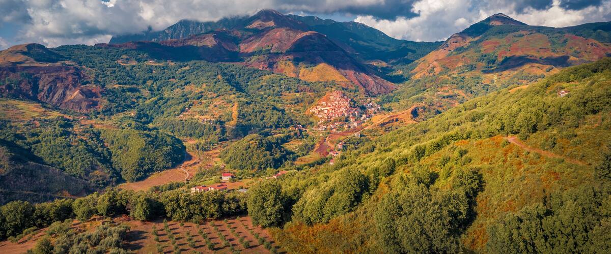 A mountainous landscape with a village nestled in the valley.