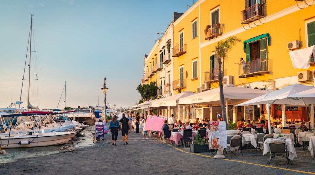 Ischia Port showing a bay or harbor, outdoor eating and a sunset